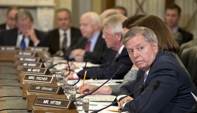 
              Sen. Lindsey Graham, R-S.C., waits to make a statement in opposition to President Obama